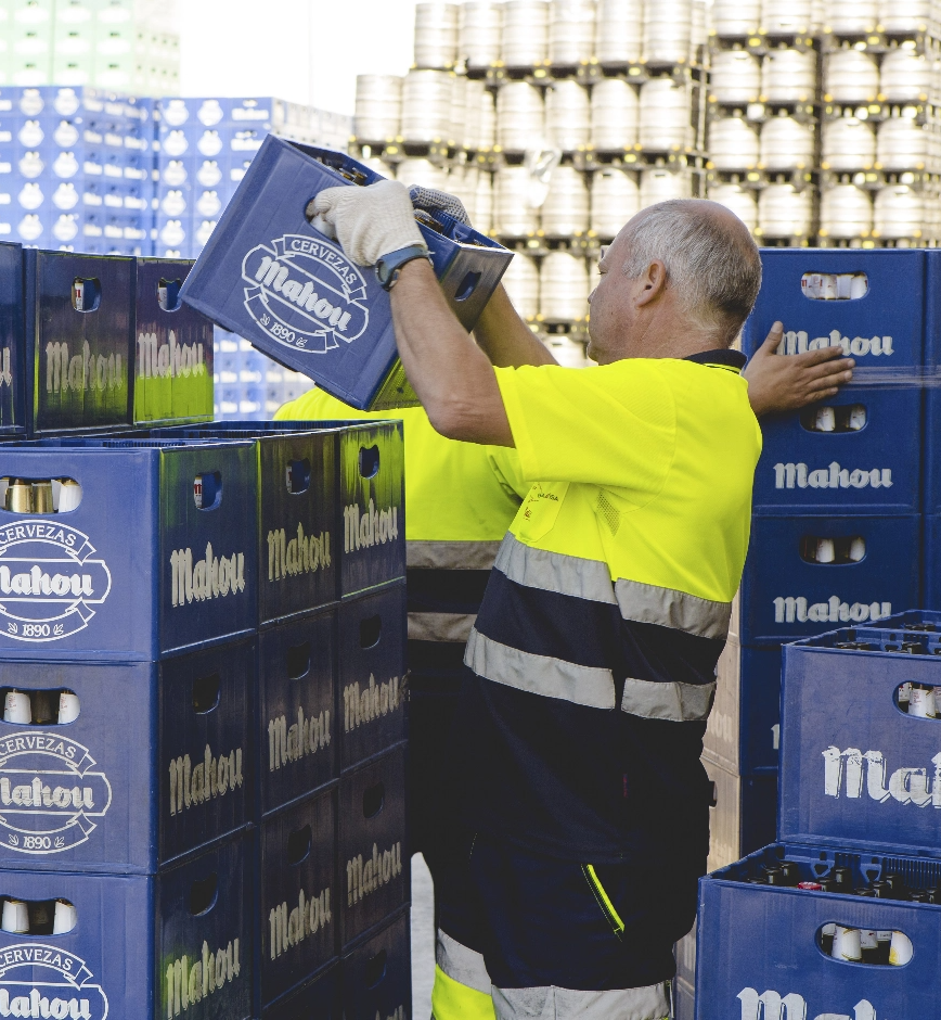 Un trabajador moviendo cajas de cervezas